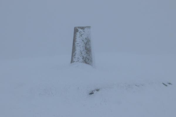 Photo of Snow up to base of summit triangulation pillar