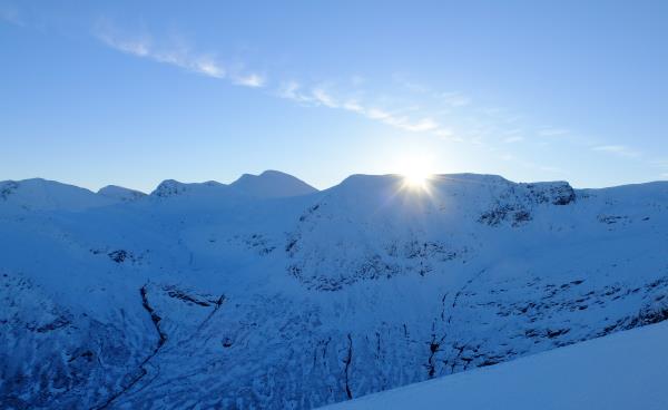Photo of Sun just rising above Mamores